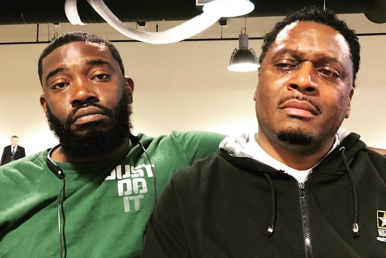 Daymond Garner, 29, was shot and killed inside his home last year. Here, his uncle, Daniel Garner (left), and his father, Daymond Garner (right), are pictured at a “next of kin” meeting with Philadelphia Police.