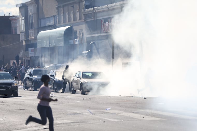 Crowds loot stores on 52nd and Chestnut Streets, in West Philadelphia, Sunday, May 31, 2020.
