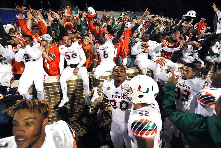 The Miami Hurricanes celebrate with their fans after beating the Duke Blue Devils 30-27 at Wallace Wade Stadium.