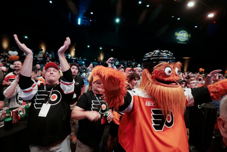 Flyers fans (L-R) Thomas  Kershalla of Beachwood, N.J., Steve Bowen of Millville and Gritty of Philadelphia cheer the Flyers draft pick during the Flyers draft party at the Hard Rock Hotel & Casino Atlantic City on Friday night, June 27, 2025.
