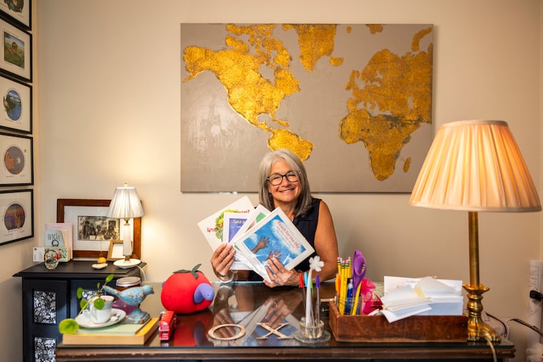 Allison Stoutland poses for a portrait holding the children’s books she wrote on Sept. 25.