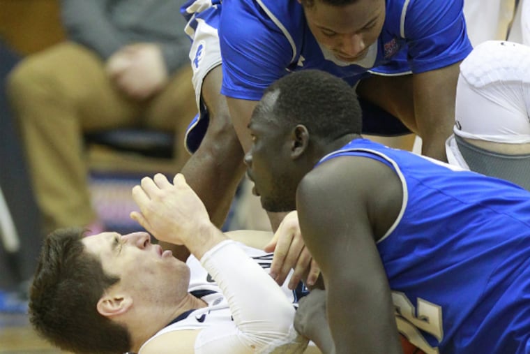 Villanova's Ryan Arciadiacono reacts after being hit in the face on a fight over a loose ball in Monday's game against Seton Hall. The Pirates suspended Sterling Gibbs for two games. (Charles Fox/Staff Photographer)