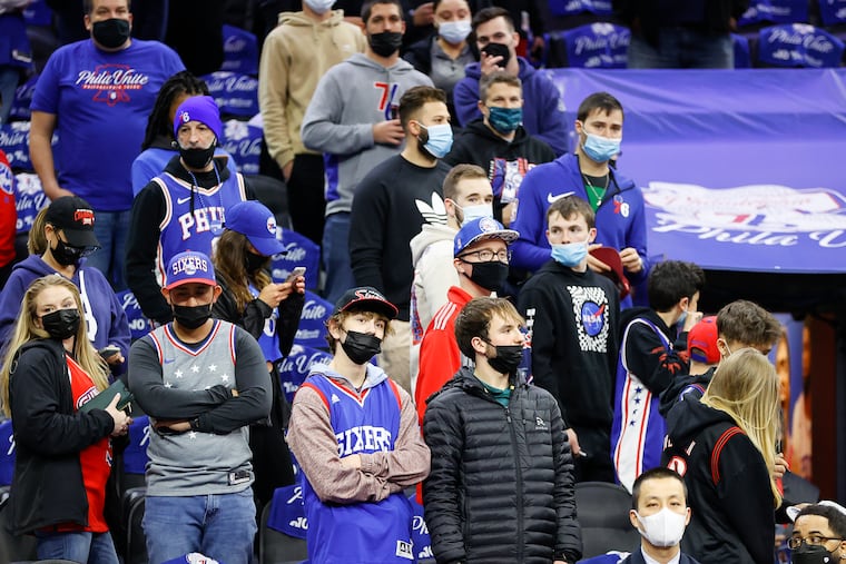 Masked Sixers fans watch pregame warm-ups before the Sixers play the Toronto Raptors in game two of the Eastern Conference quarterfinals playoffs after Philadelphia reinstated an indoor mask mandate on Monday.