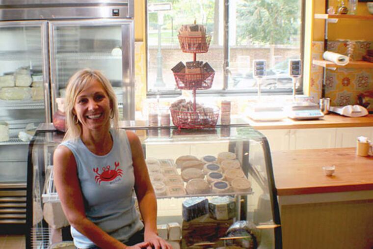 Aimee Olexy by the cheese counter at Talula's Daily, which is also a showcase for the retailer Anthropologie. (Michael Klein/Philly.com)