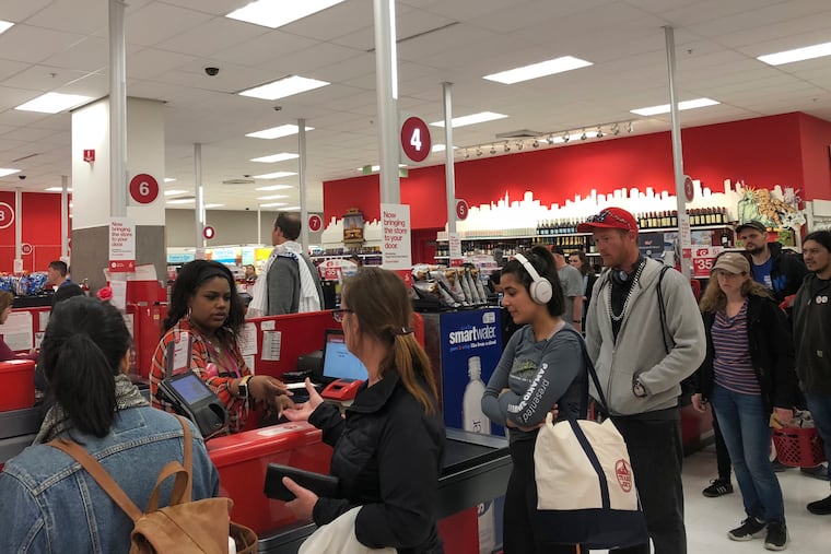 Customers wait on a long check out line at a Target store in San Francisco on Saturday, June 15, 2019. Target suffered a technological glitch that stalled checkout lines at its stores worldwide Saturday, exasperating shoppers and eating into sales at a prime time for retailers. The outage periodically prevented Target's cashiers from scanning merchandise or processing transactions. Self-checkout registers also weren't working at times, causing massive lines in some stores. (AP Photo/Michael Liedtke)