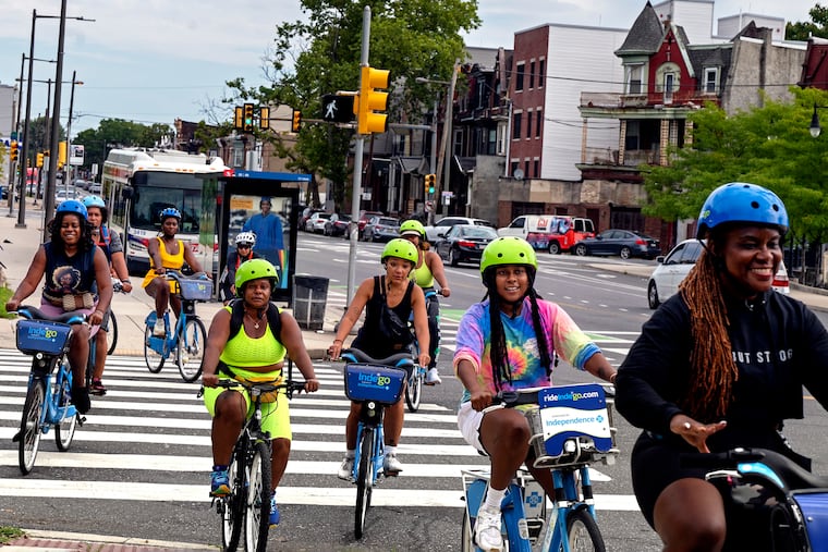 Participants in the Black Girl Joy Bike Ride travel 33rd Street, along part of the legendary Boxers’ Trail in North Philly Sunday, Aug. 11, 2024. Iresha Picot (not shown) founded the group for Black women bike riders and hosts the meet up every other week to ride with each other and build community.
