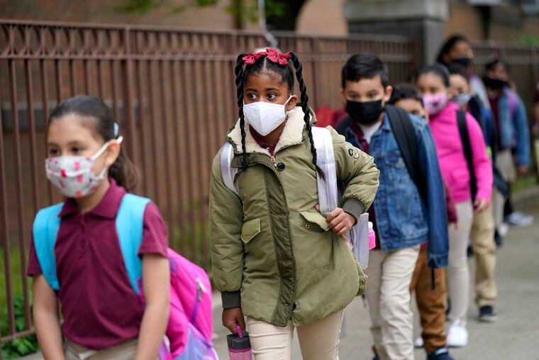Students enter Christa McAuliffe School in Jersey City, N.J., on April 29, 2021.