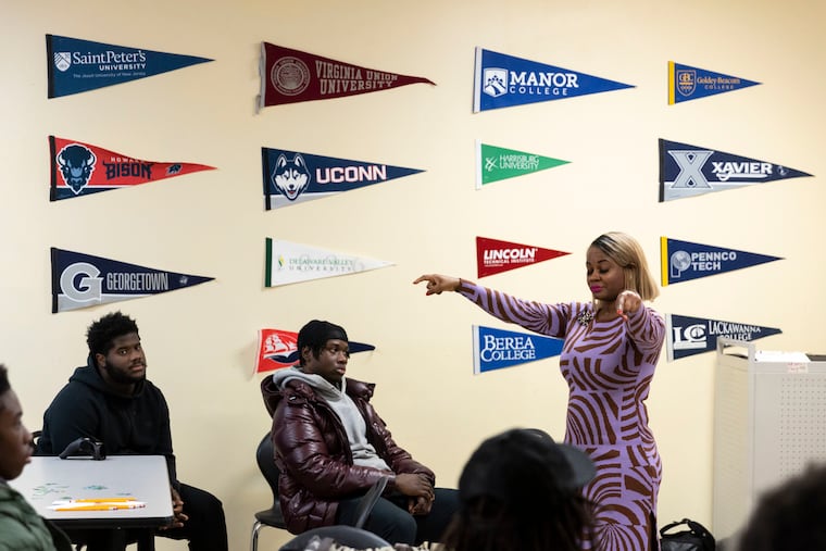 Shirley Posey leads the Imhotep Charter football team in a "brain training" session on Wednesday. Posey is the director of science, technology, engineering, and mathematics at Imhotep.