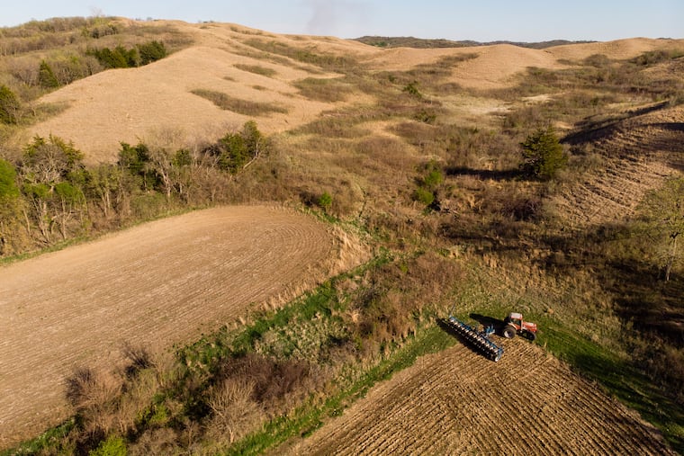 A farmer plants soybeans in Castana, Iowa, in April 2025. The per-acre value of farmland in Iowa has long surpassed the national average. Landowners and investors are increasingly trying to make money from their land, not from what can be grown on it.