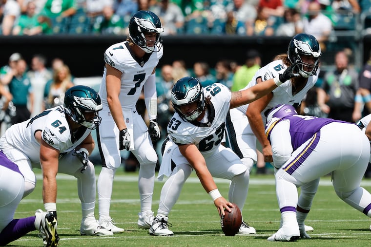 Eagles center Dylan McMahon signals at the line with quarterback Kenny Pickett during a preseason game against the Minnesota Vikings on Aug. 24.