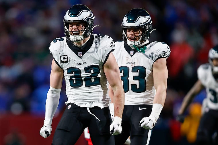 Eagles safety Reed Blankenship (32) celebrates a stop with Cooper DeJean during the second quarter of Sunday's game against the Bills in Orchard Park, N.Y.