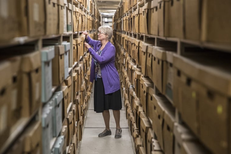 Jill Rawnsley, an archival and preservation consultant at the Philadelphia Archives, looks through some of the thousands of historical records.