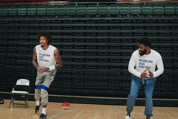 Sixers strength and conditioning coach Ben Kenyon (right) instructing Kelly Oubre Jr. as he prepared for training camp last year.