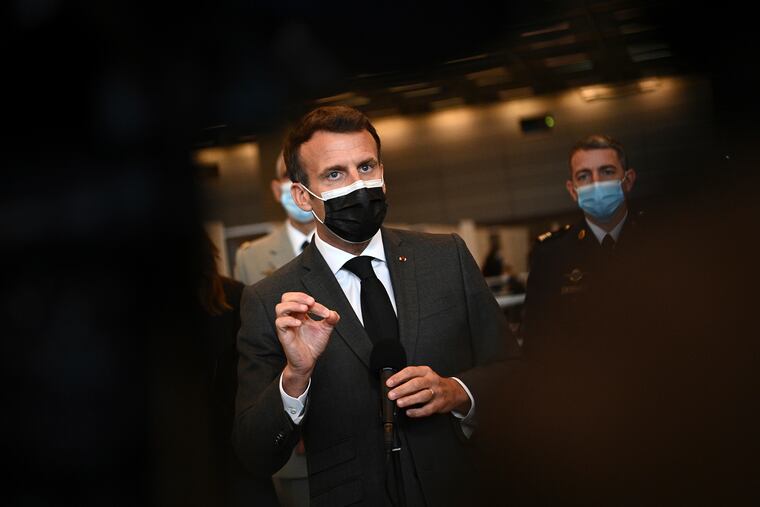 French President Emmanuel Macron talks to the press Thursday.