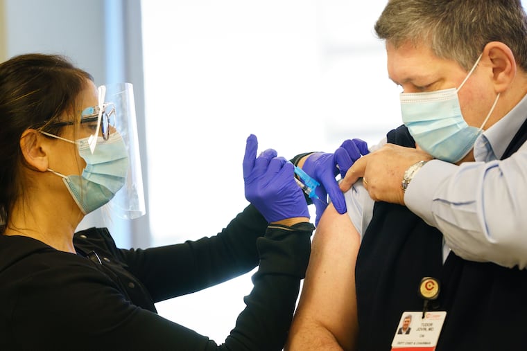 LPN Kimberly Peacock administers the COVID-19 vaccine at Cooper University Health Care to Dr. Tudor G. Jovin in December.