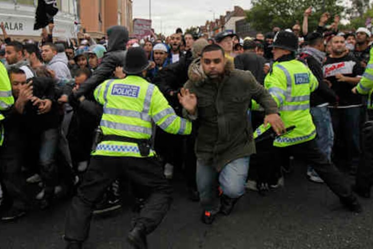 At a mosque near London, police try to restrain antifascists and Muslims from charging a Stop Islamification of Europe contingent.