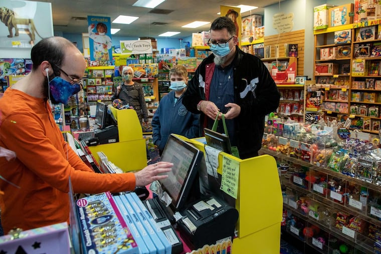 James Cavicchia (right), with his son Joseph, 12, checks out Christmas gifts he bought at Toys et Cetera in Hyde Park in Chicago last month.