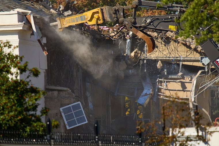 A window dangles from the East Wing of the White House as demolition work continues on Tuesday, before construction of a new ballroom.