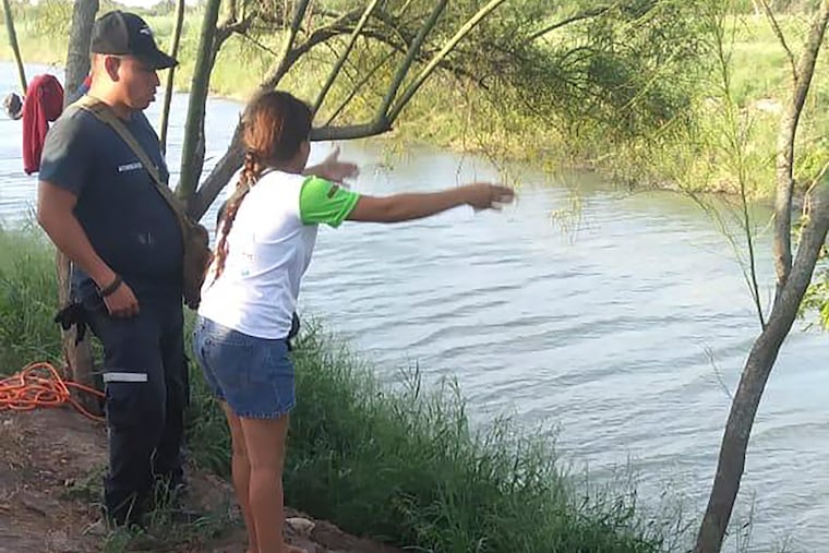 In this Sunday, June 23, 2019, photo, Tania Vanessa Ávalos of El Salvador speaks with Mexican authorities after her husband and nearly 2-year-old daughter were swept away by the current in Matamoros, Mexico, while trying to cross the Rio Grande to Brownsville, Texas. Their bodies, the toddler still tucked into her father's shirt with her arm loosely draped around him, were discovered Monday morning several hundred yards from where they had tried to cross.