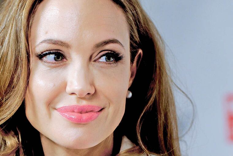 FILE - This March 8, 2012 file photo shows actress Angelina Jolie at the Women in the World Summit in New York. Jolie says that she has had a preventive double mastectomy after learning she carried a gene that made it extremely likely she would get breast cancer. The Oscar-winning actress and partner to Brad Pitt made the announcement in an op-ed she authored for Tuesday's New York Times under the headline, "My Medical Choice." She writes that between early February and late April she completed three months of surgical procedures to remove both breasts. (AP Photo/Evan Agostini, file)