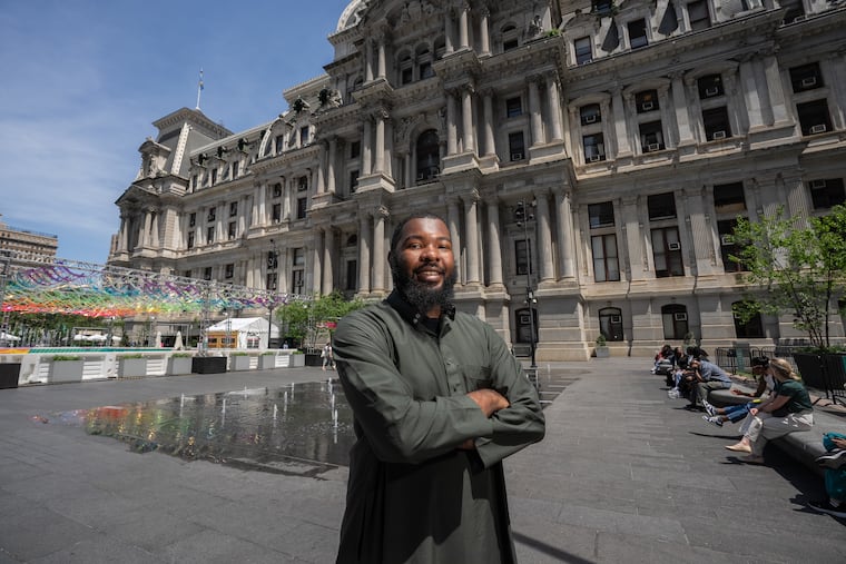 George Lane, a senior at the Academy at Palumbo, the winner of a Gates Millennium Scholarship, which offers a full ride through graduate school, is shown here outside City Hall.