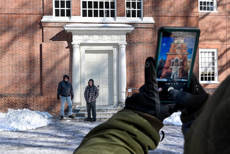 Todd Bolin (left) from Daytona Beach and Paul Pascone (right) from Los Angeles have a Independence National Historical Park Ranger take a photo them outside Independence Hall on Thursday, Jan. 29, 2026.