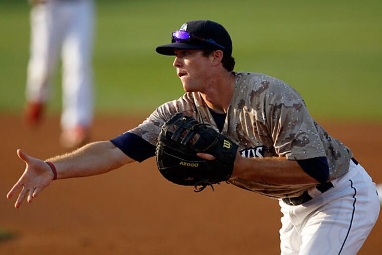 Zach Green tossing the ball to first base against the Hagerstown Suns. (Yong Kim/Staff Photographer)