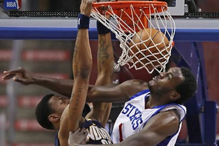 Samuel Dalembert had a close-up view of this dunk by Brandon Rush during the first quarter. (Ron Cortes/Staff Photographer)