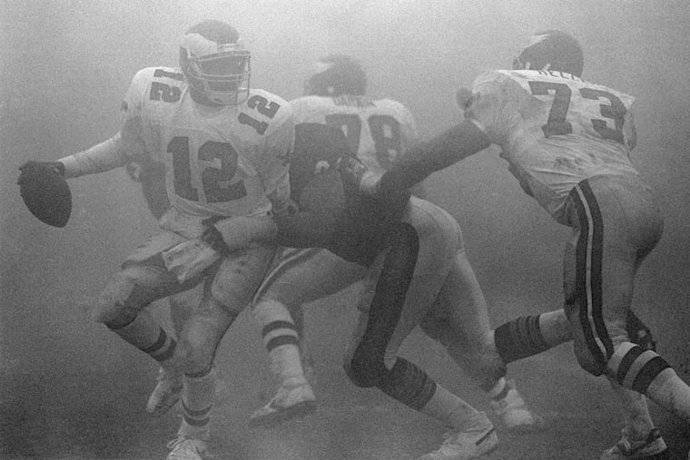 Randall Cunningham scrambles in the fog at Soldier Field in Dec. 31, 1988. Cunningham and the Eagles were stymied by the Bears defense and the intense fog that swept into Chicago around halftime of an NFC divisional playoff game.