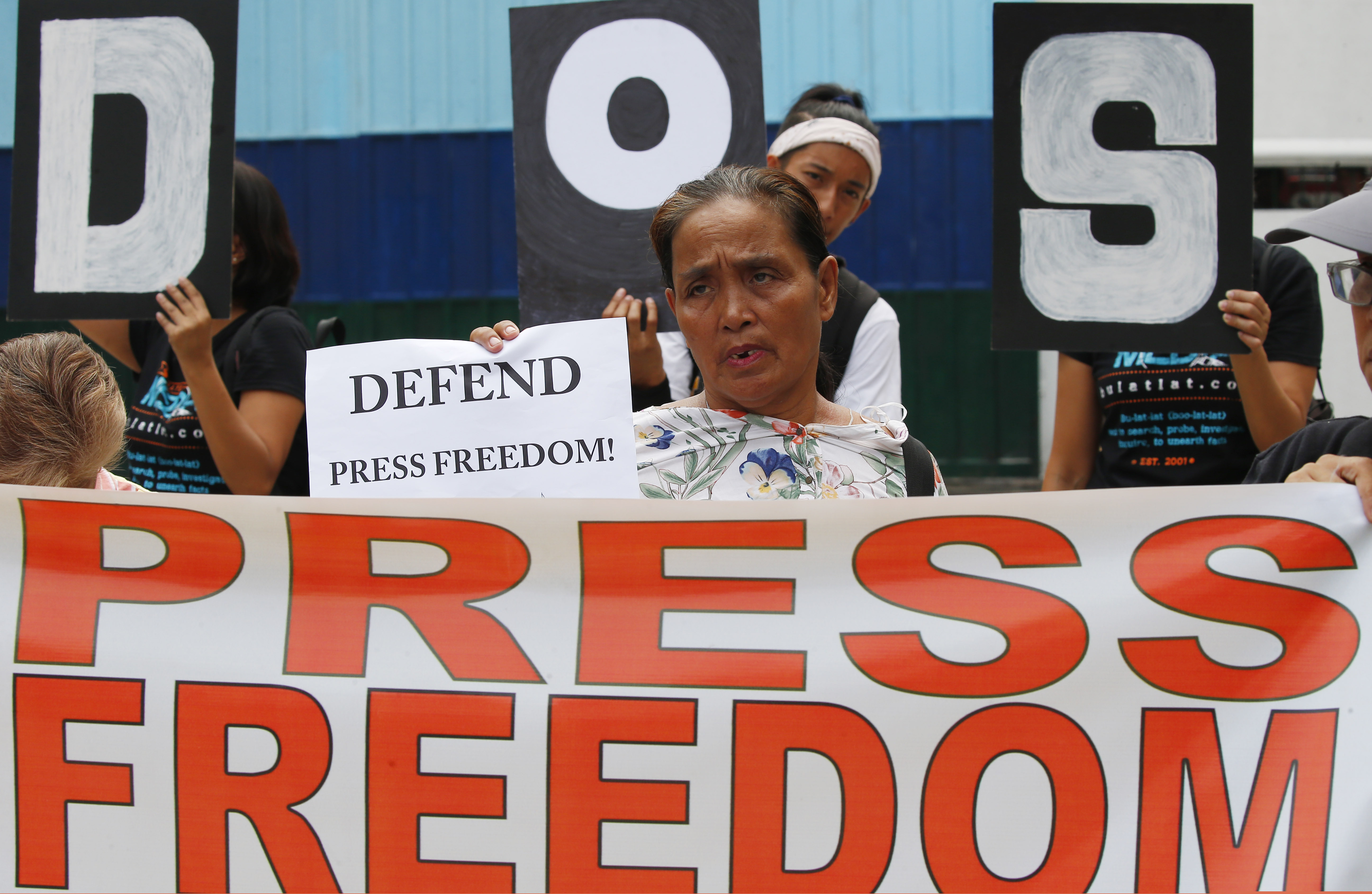 In this May 3, 2019 photo, protesters rally outside the armed forces headquarters to mark World Press Freedom Day, which was declared by the UN General Assembly in Manila, Philippines. The Philippine government’s chief lawyer is asking the Supreme Court to shut down the country’s largest TV network by revoking its operating franchises because of alleged constitutional violations, in a move critics call an attempt to muzzle the media.