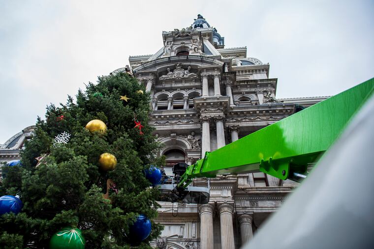 A crew from Proof Productions decorate the City's holiday tree at City Hall in Philadelphia, Pa, on Nov. 22, 2019.