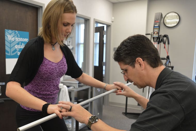Dr. David Aiken works with Haley Pillars on her physical therapy in Charlotte, North Carolina, on April 15, 2013. (Davie Hinshaw/Charlotte Observer/MCT)