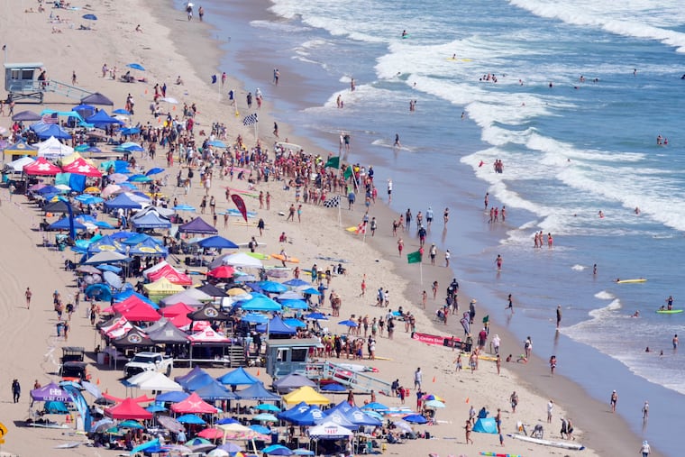 Beach goers watch during the the 46th annual California Surf Lifesaving Championships on Will Rogers State Beach Friday, July 24, 2026, in the Pacific Palisades section of Los Angeles. s