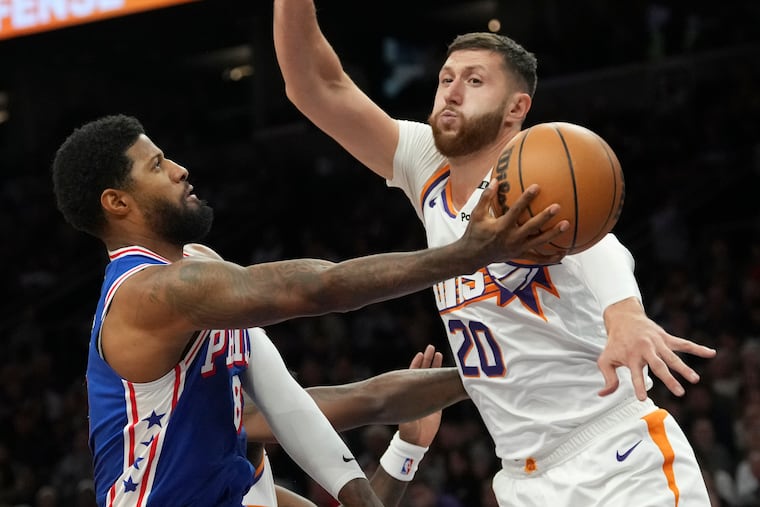 Paul George (left) made 4 of 14 shots Monday night in his Sixers debut.