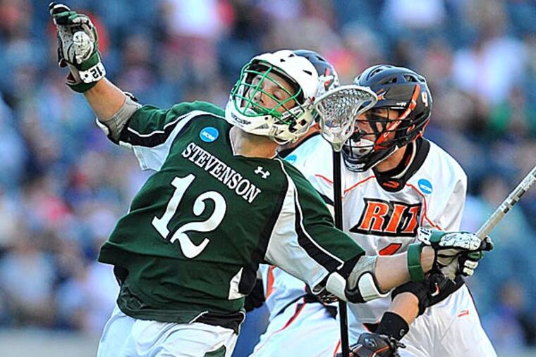 Stevenson College midfielder Peter Green gets checked by Rochester Institute of Technology's defenseman Evan Burley in the NCAA Div. III championship game. (Clem Murray/Staff Photographer)