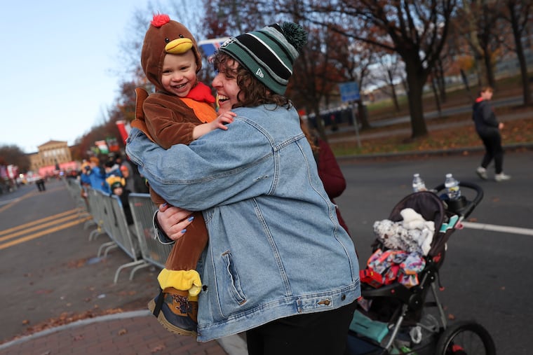Faith Brachelli holds nephew Max, 2, as they wait for the parade to come by during the 2023 6abc Dunkin' Thanksgiving Day Parade.