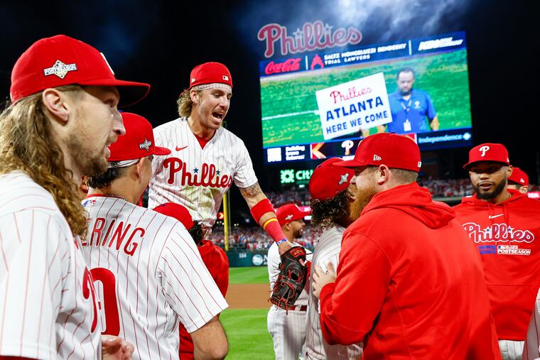 Bryson Stott (center) celebrates a victory with teammates following Game 2 against the Marlins.