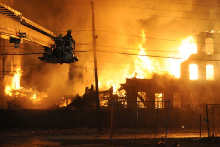 Firefighters fight a blaze Saturday morning that grew to an eight-alarm fire. Officials said all residents were evacuated safely but some were temporarily displaced. (Curt Hudson)