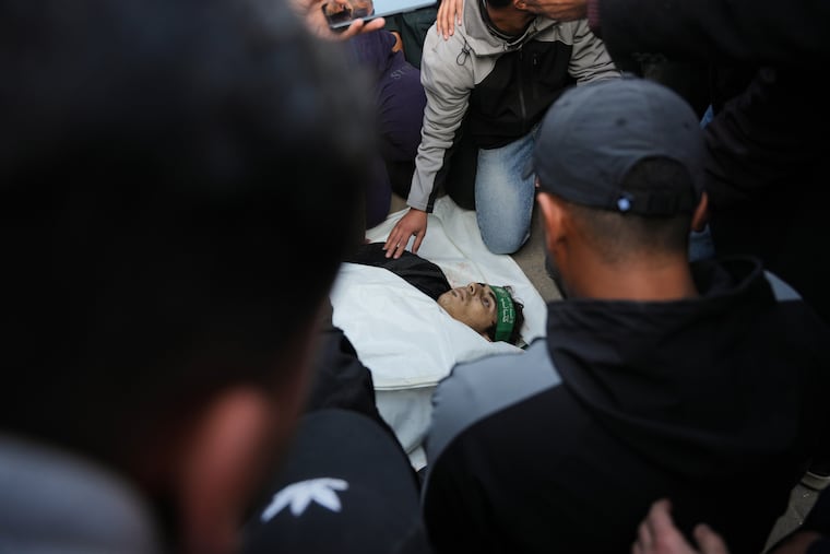 Palestinians mourn over the body of Hamas militant Firas al-Najjar, who was killed in an Israeli military strike, during his funeral at Nasser Hospital in Khan Younis, Gaza, Sunday, Feb. 15, 2026.