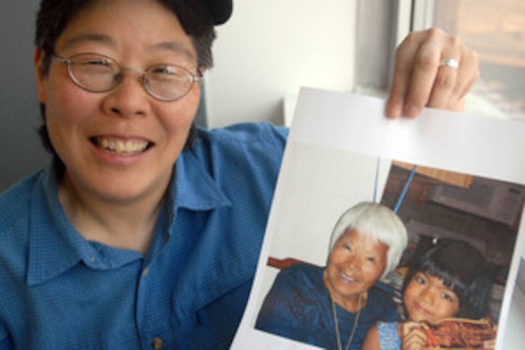 Ellen Somekawa holds a photo of her mother, Mari Kawanami Somekawa, and daughter, Chi Joselyn.