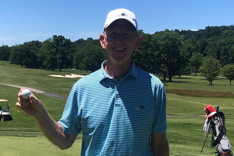 Rich Lownes holds up the ball after one of his two improbable holes-in-one Saturday at Manufacturers Golf and Country Club in Oreland.
