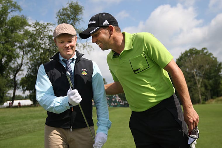 Sergio Garcia (right) takes a look at the 1-iron that Ben Hogan used to hit one of the most famous shots in U.S. Open history. (Michael Bryant/Staff Photographer)