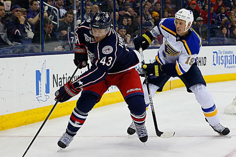 Blue Jackets left wing Scott Hartnell keeps the puck away from Blues defenseman Jay Bouwmeester. (Russell LaBounty/USA Today Sports)