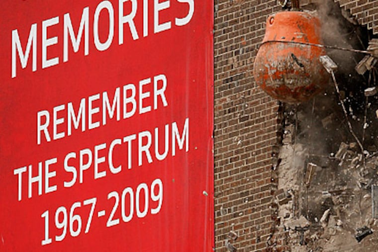 A wrecking ball strikes the outside wall of the Spectrum during the "Final Shot" event. (David Maialetti / Staff Photographer)