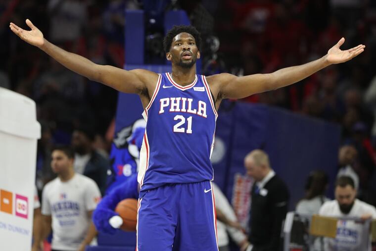 Joel Embiid of the Sixers raises his arms to the crowd during the Sixers win over Portland on Nov. 22, 2017. CHARLES FOX / Staff Photographer