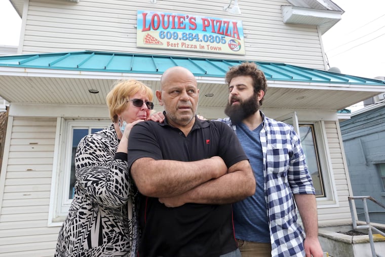 Mohamed Abdelsalam, center, son, Yoseph,and wife, Lisa, outside the closed Louie’s Pizza, in Cape May, Wednesday, April 22, 2021.