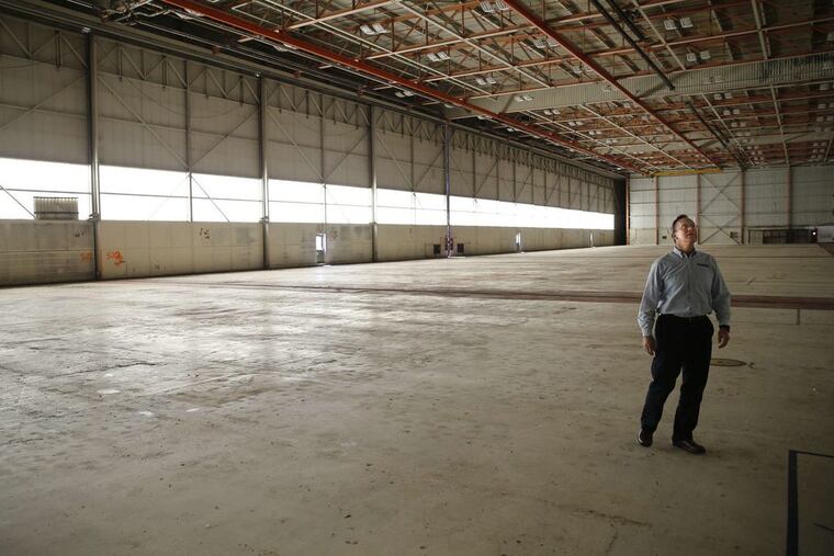Marty Schy, a veteran Navy pilot who works as a caretaker at the Willow Grove Naval Air Station, looks up at the ceiling of Hangar 175, through which chemical-laden firefighting foam once was piped.