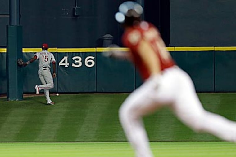 Phillies centerfielder John Mayberry tracks down J.D. Martinez's triple in the second inning of Sunday's loss. (David J. Phillip/AP)