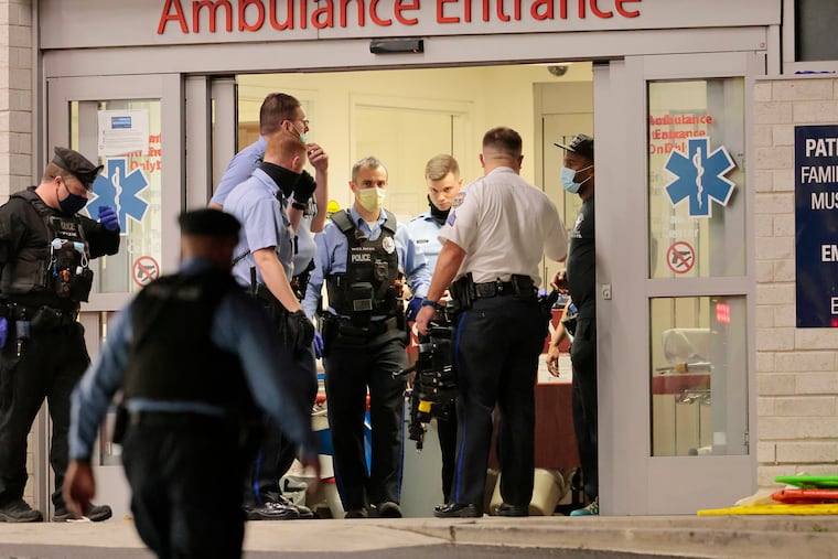 Shortly before 2 a.m., Philadelphia police gather at Penn Presbyterian Hospital after two officers were shot in an exchange of gunfire with the suspect wanted in the fatal Jefferson Hospital shooting that occurred a short time earlier.