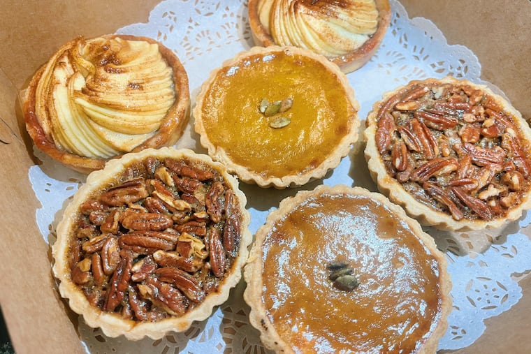 An assortment of 4" tarts from Tartes at 212 Arch Street in Old City, Philadelphia. Clockwise from right to left: apple, bourbon pecan, and pumpkin.
